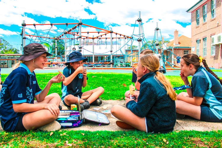 Students enjoying lunch in our colourful playground.